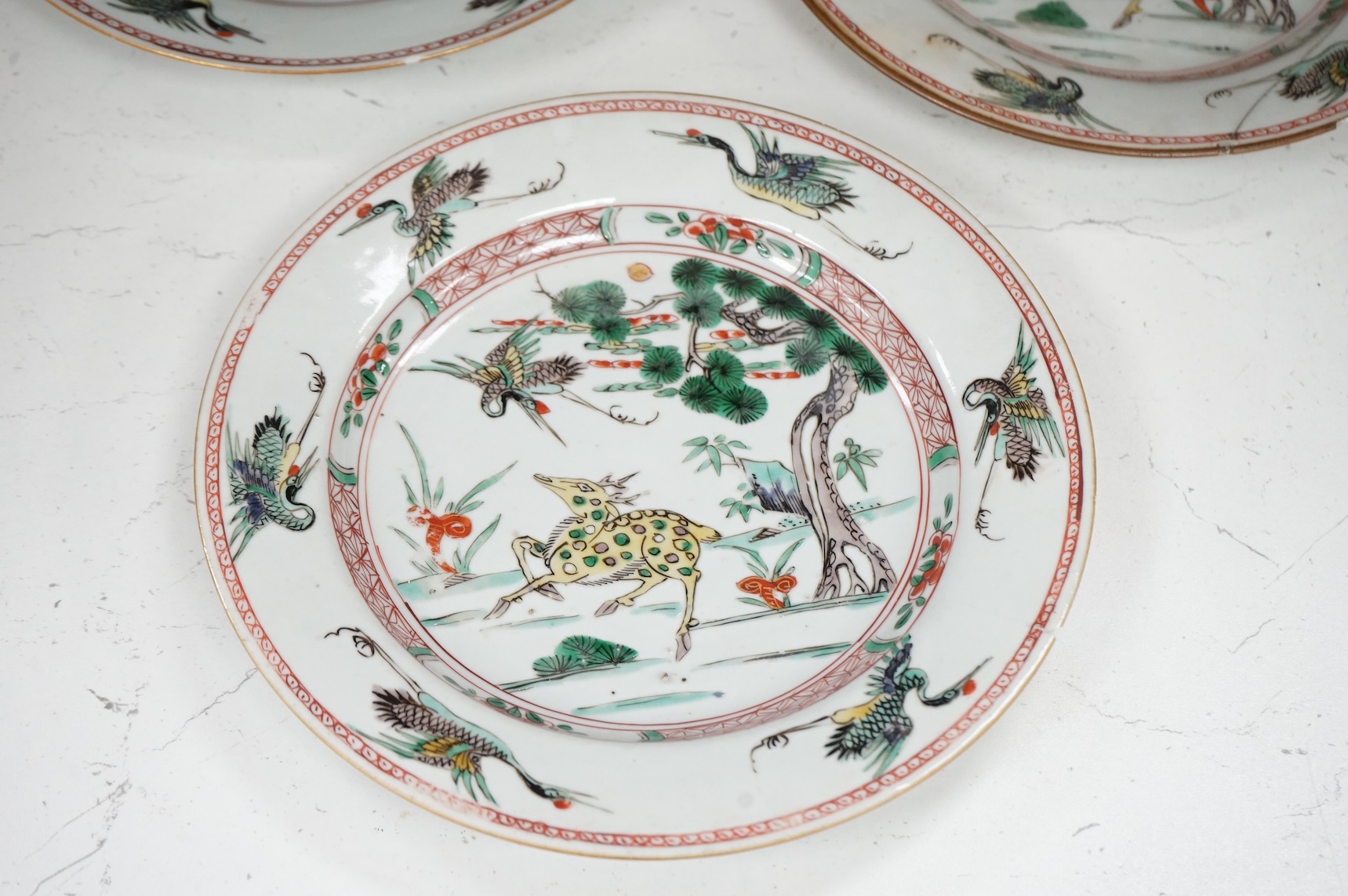 Three Chinese famille verte deer and crane plates, Kangxi period, 22cm in diameter